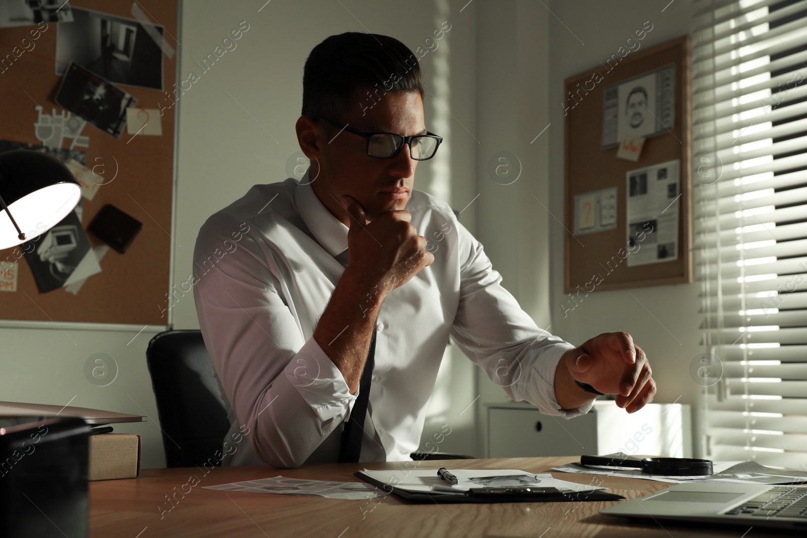 Photo of Detective working at desk in his office