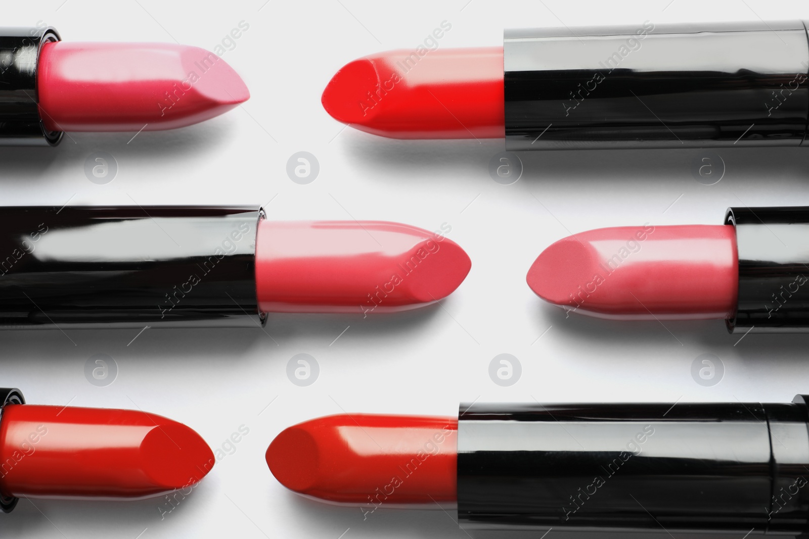 Photo of Flat lay composition with lipsticks on white background