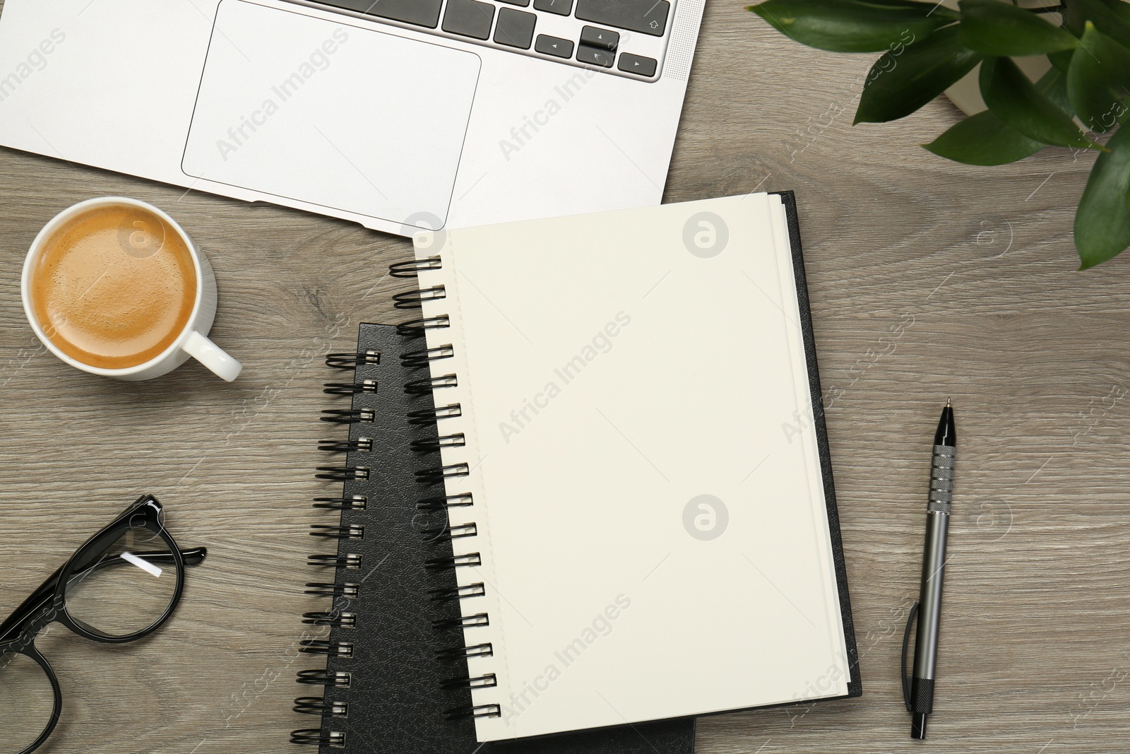 Photo of Flat lay composition with notebooks and laptop on wooden table