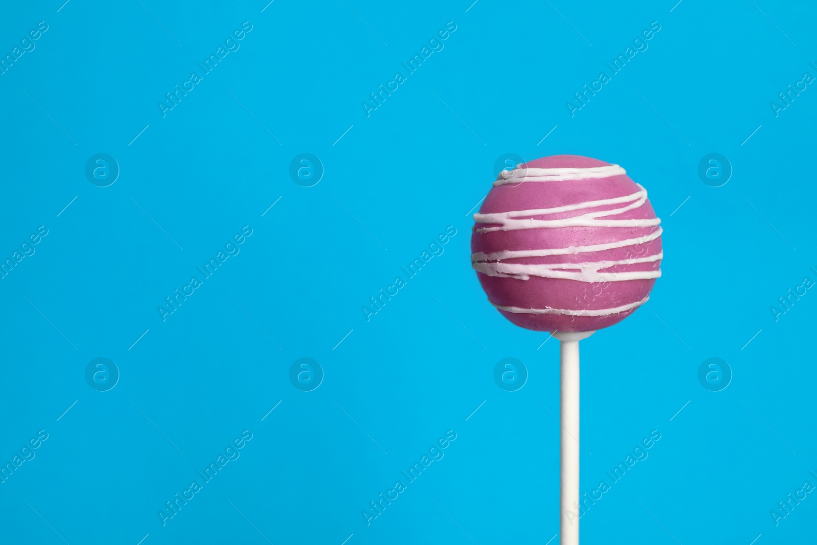 Photo of Bright delicious cake pop on color background. Space for text