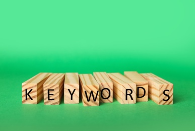 Photo of Blocks with word KEYWORDS on green background