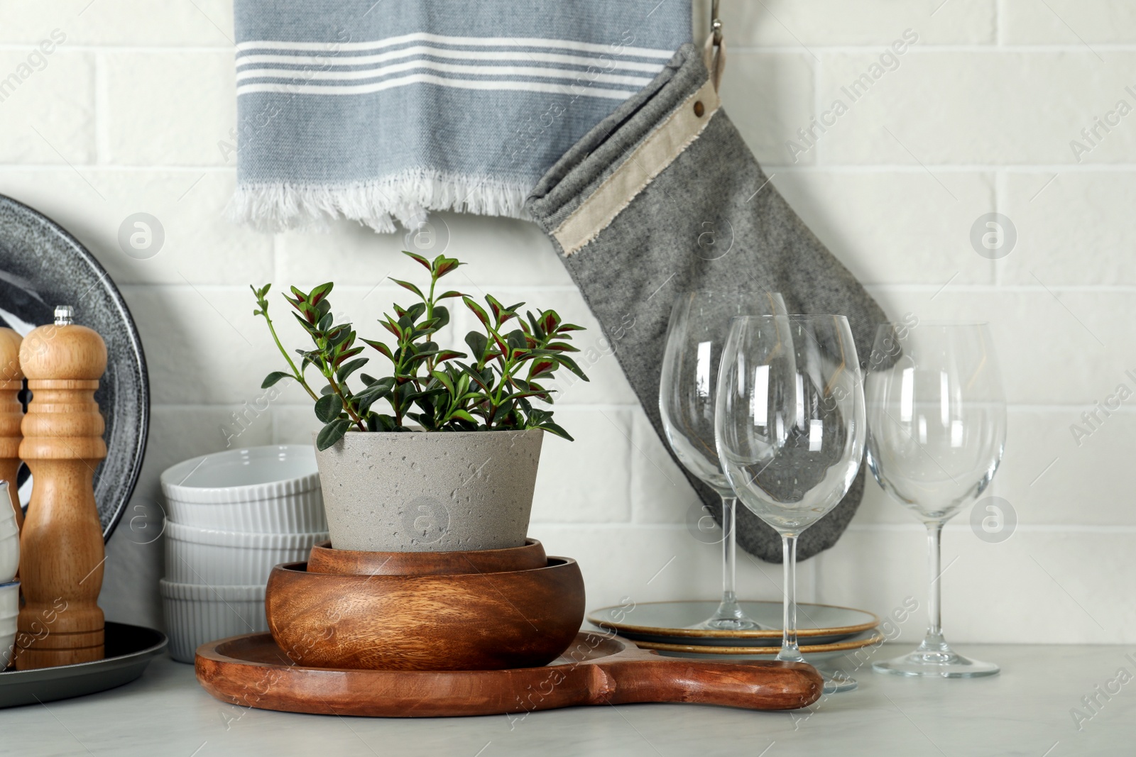 Photo of Set of clean tableware on white countertop in kitchen