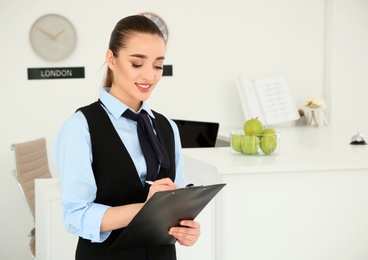 Portrait of female receptionist at workplace in hotel