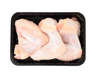 Photo of Plastic container with raw chicken wings on white background, top view. Fresh meat