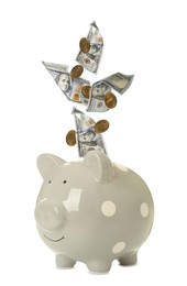 Image of Money falling into grey piggy bank on white background