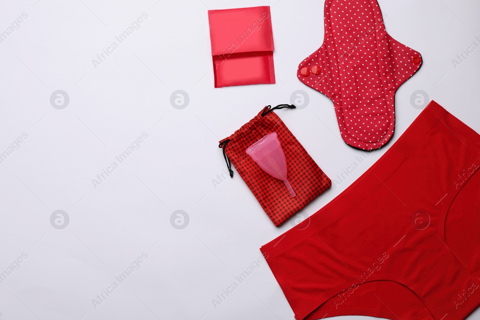 Photo of Women's underwear, disposable and reusable female hygiene products on white background, flat lay. Space for text