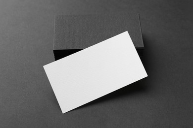 Blank business cards on black background, closeup. Mockup for design