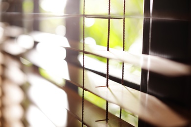 Photo of Closeup view of sunlit horizontal window blinds