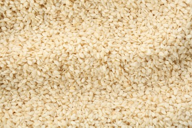 Photo of Pile of white sesame seeds as background, top view
