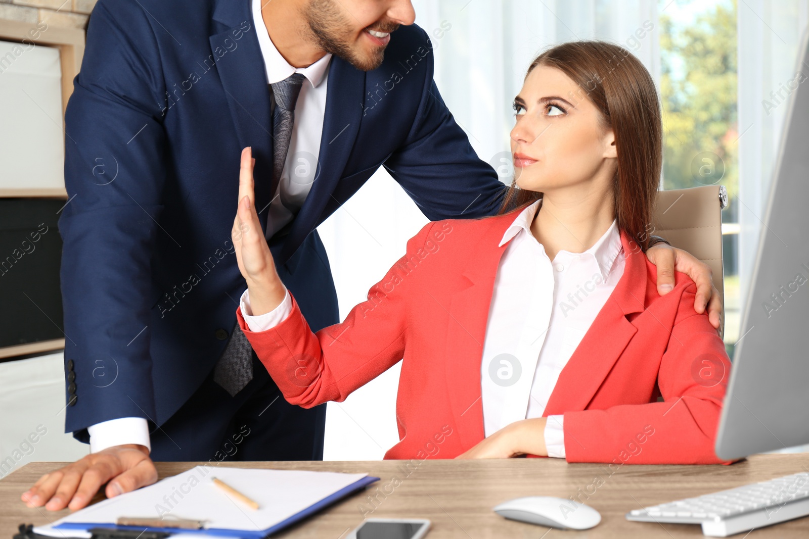 Photo of Boss molesting his female secretary in office. Sexual harassment at work