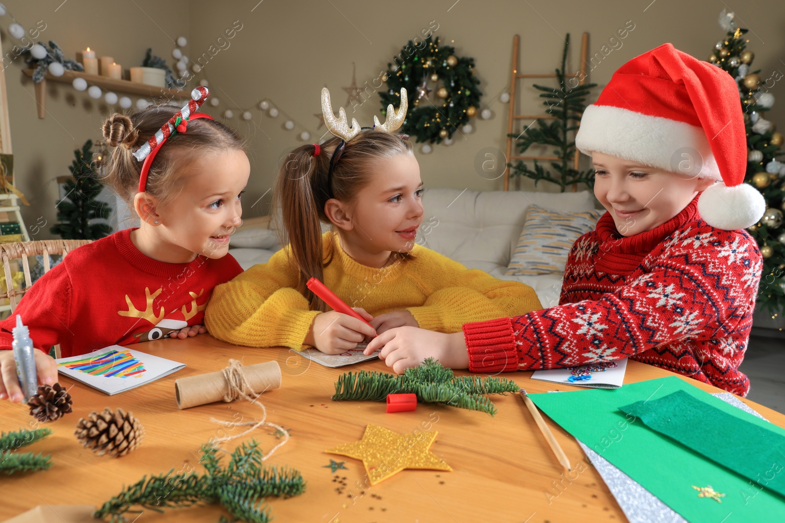 Photo of Cute little children making beautiful Christmas greeting cards at home