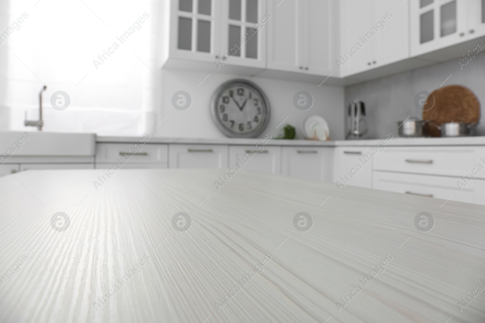 Photo of White wooden table in kitchen, closeup. Interior design