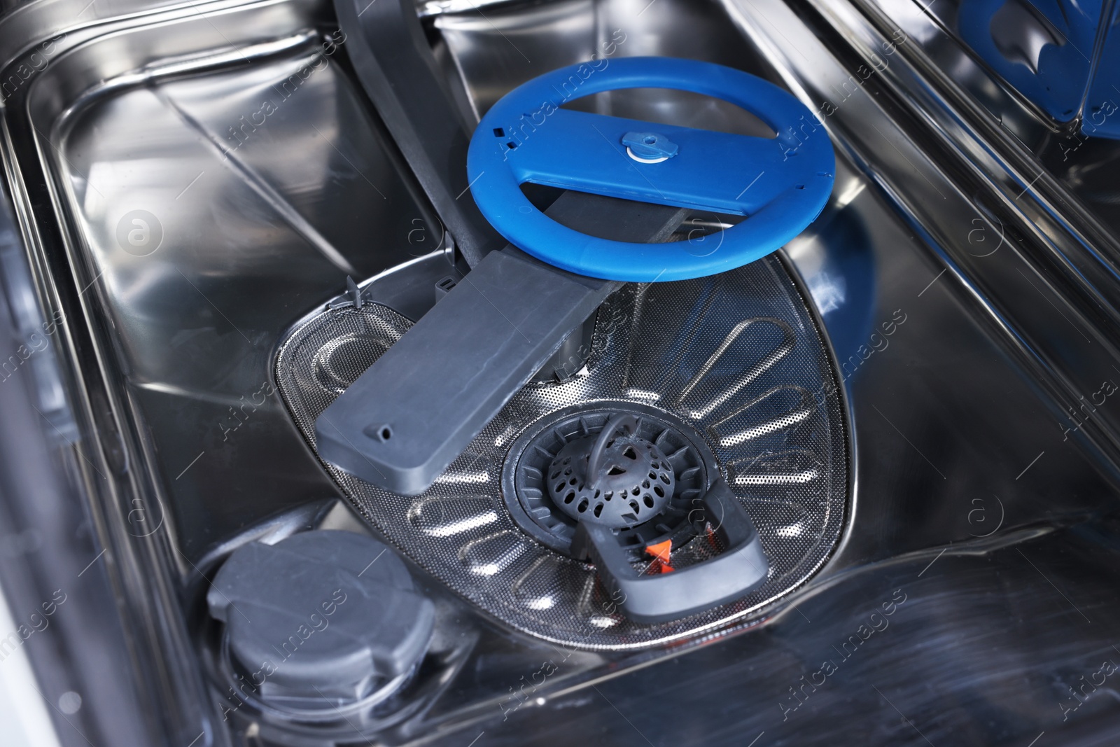 Photo of Open clean empty dishwasher, closeup. Home appliance