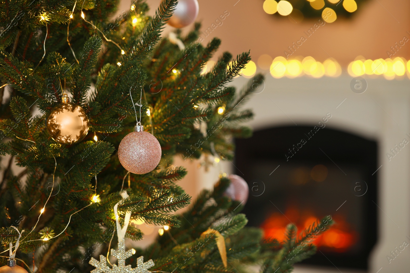 Photo of Beautiful Christmas tree decorated with festive lights and baubles indoors, space for text. Bokeh effect