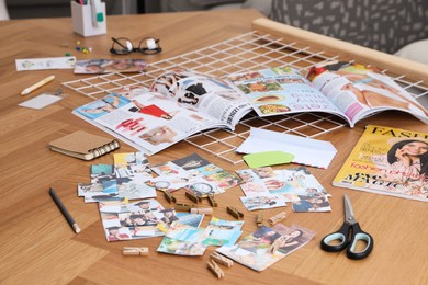 Photo of Composition with different photos, magazines and metal grid on wooden table indoors. Creating vision board