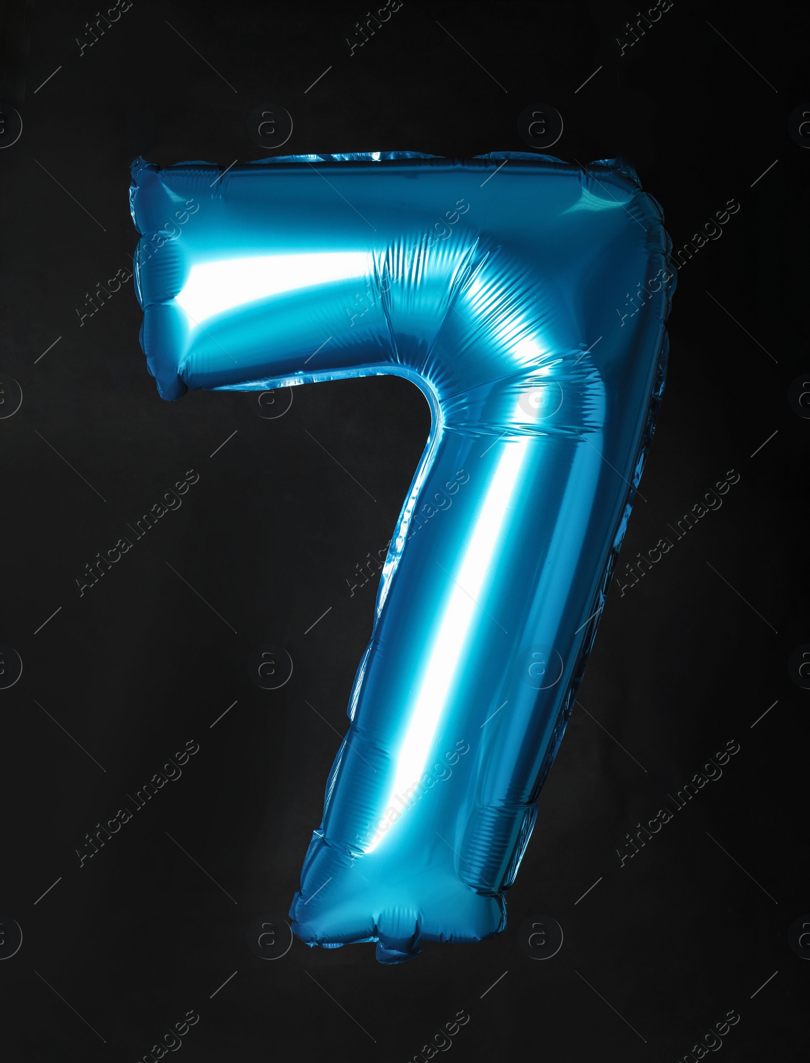 Photo of Blue number seven balloon on black background