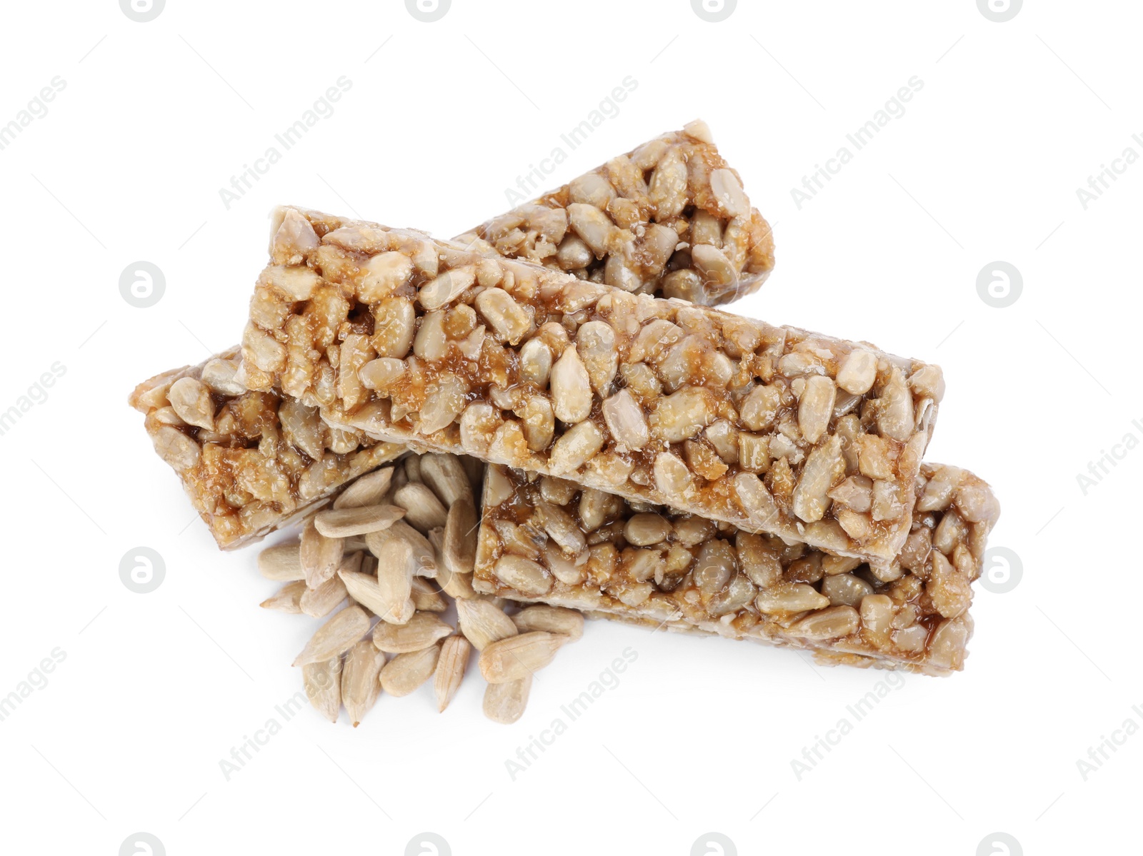 Photo of Delicious sweet kozinaki bars and sunflower seeds on white background, top view