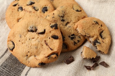 Photo of Delicious chocolate chip cookies on fabric, closeup
