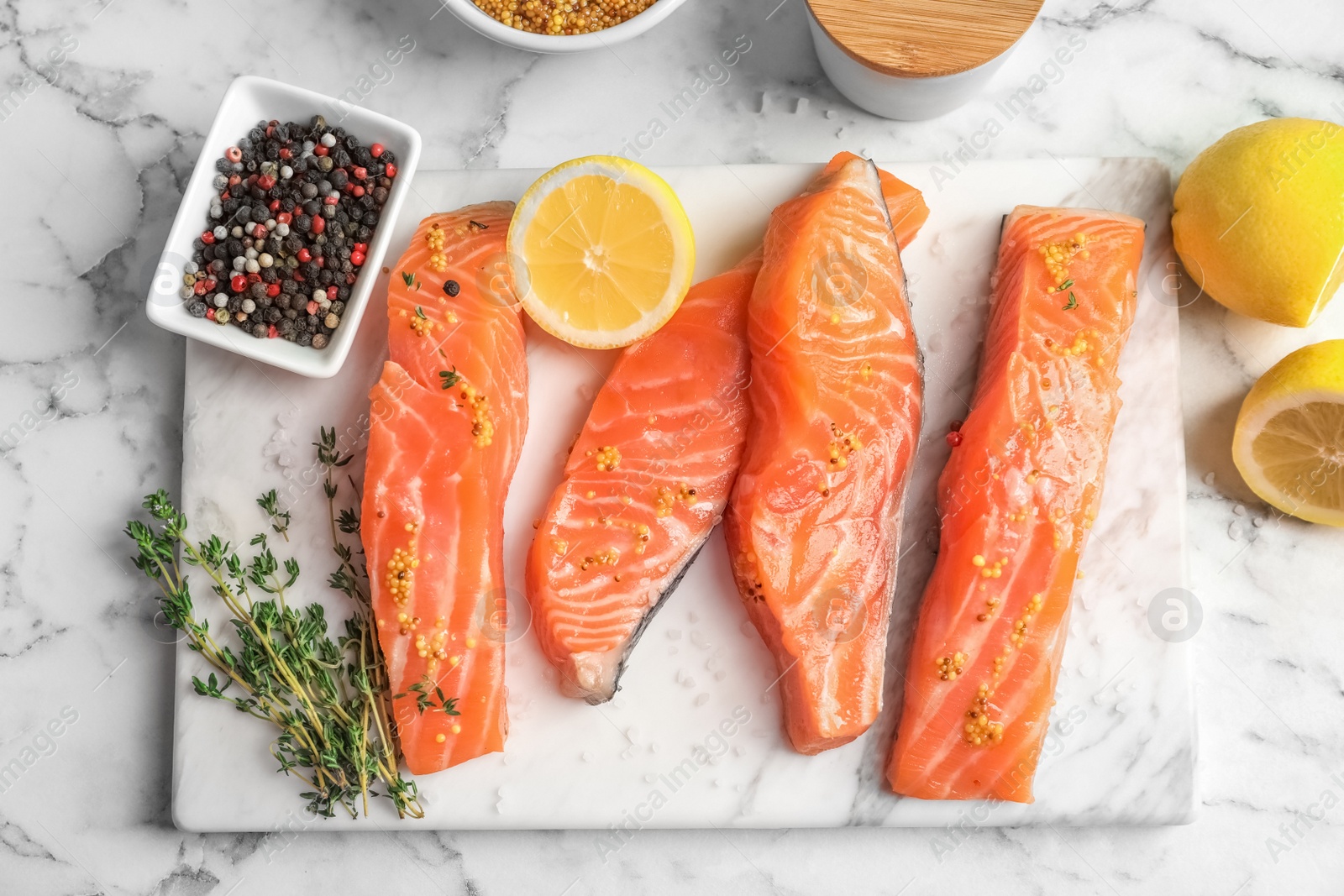 Photo of Fresh salmon and ingredients for marinade on table, top view