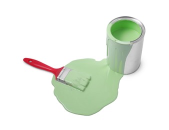 Photo of Spilled paint, brush and can on white background