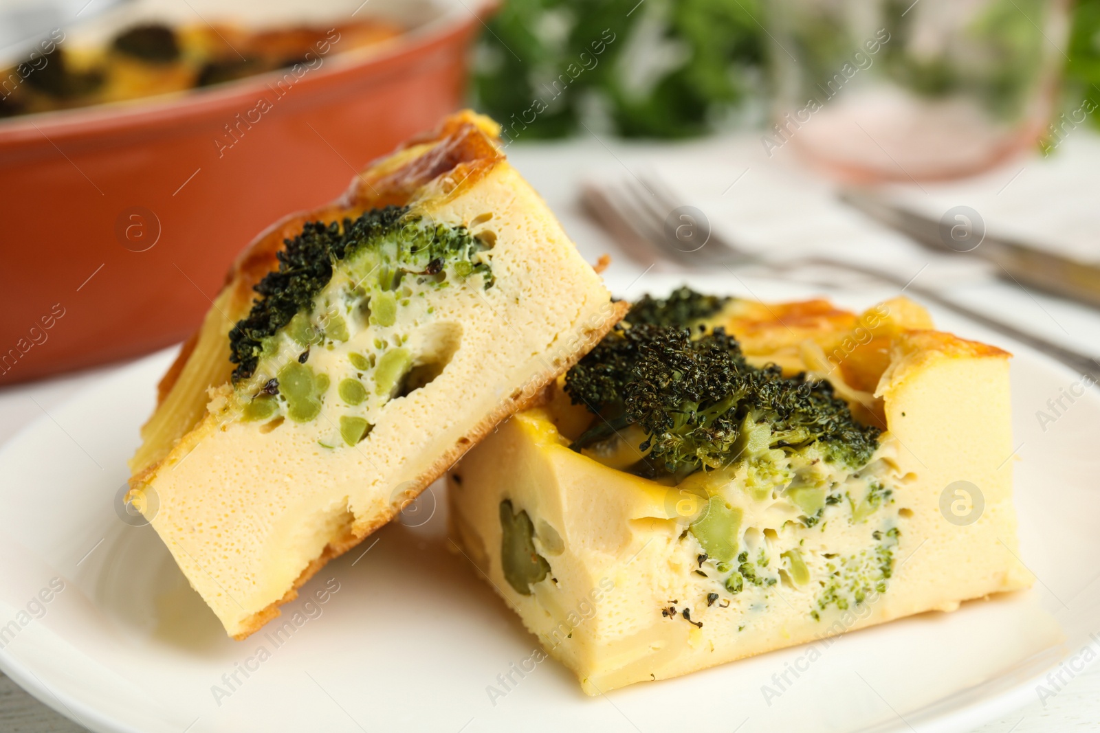 Photo of Tasty broccoli casserole on white plate, closeup