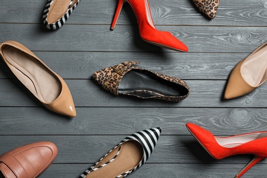 Photo of Flat lay composition with stylish shoes on wooden background