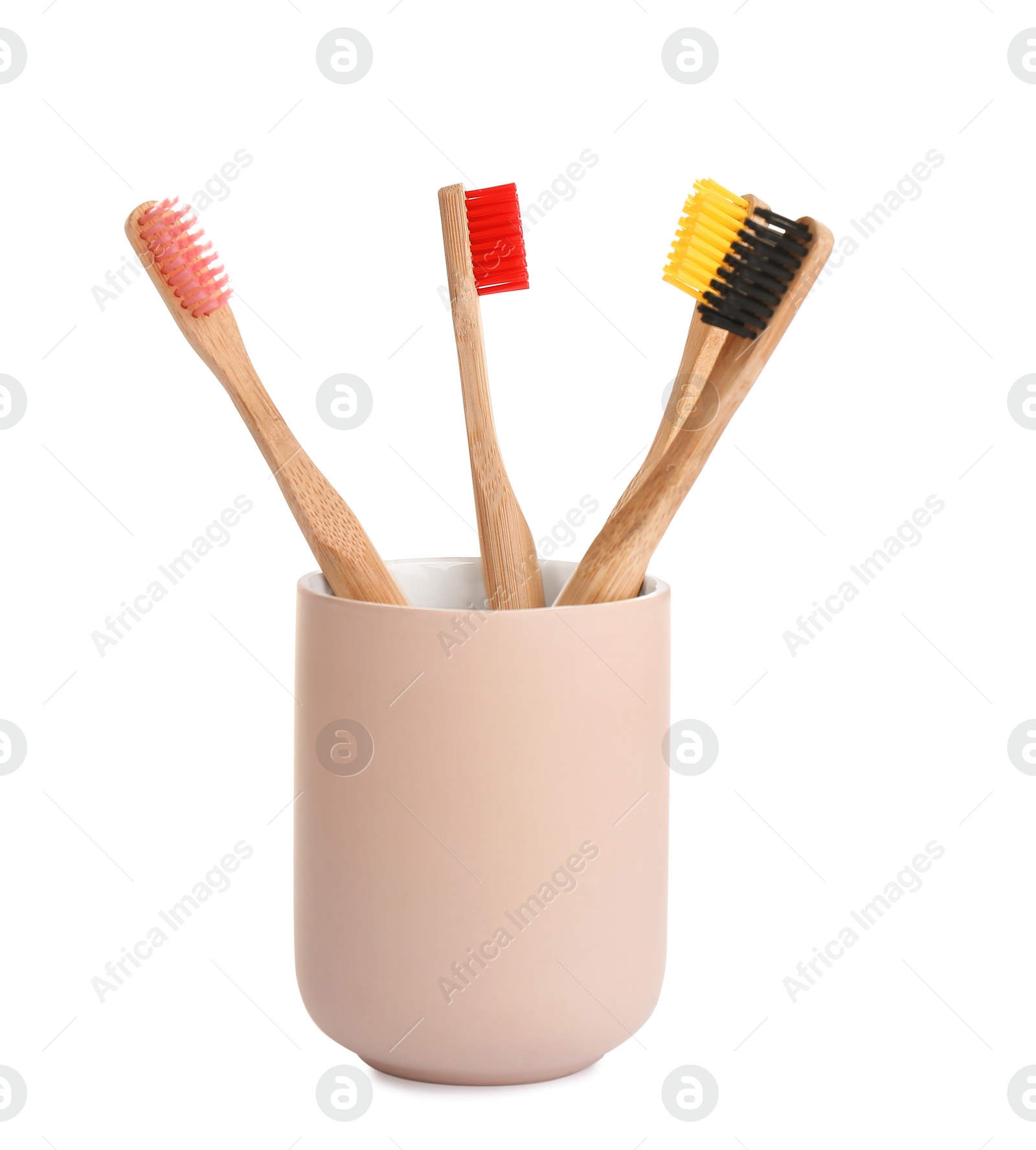 Photo of Bamboo toothbrushes in holder isolated on white