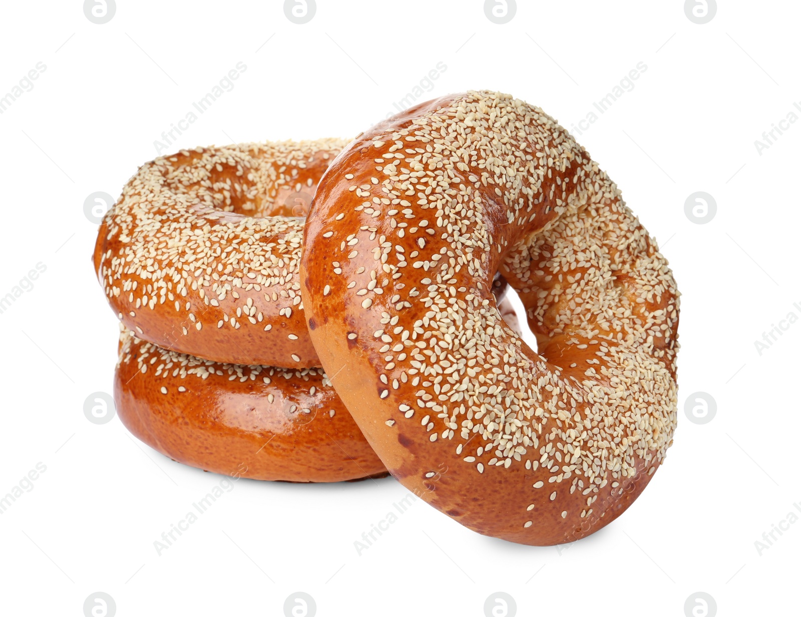 Photo of Delicious fresh bagels with sesame seeds on white background