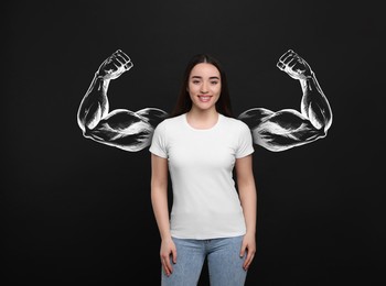 Happy woman and illustration of muscular arms behind her on black background
