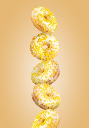 Tasty donuts with sprinkles on light orange background