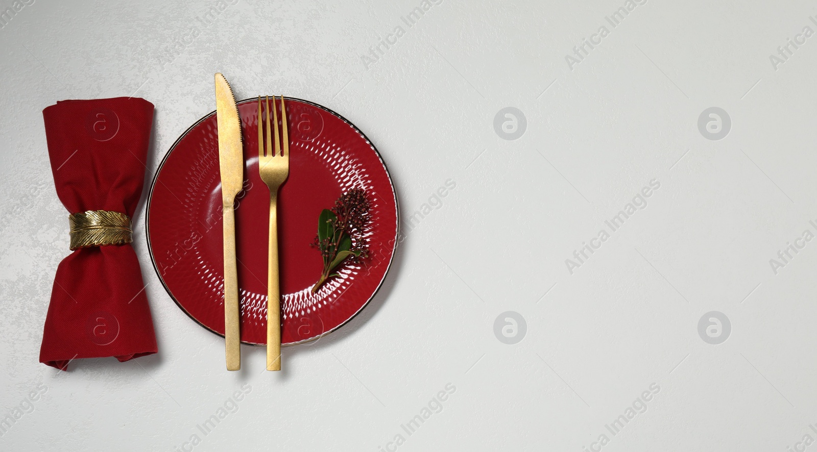 Photo of Stylish setting with elegant cutlery on white table, top view. Space for text