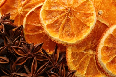 Photo of Dry orange slices and anise stars as background, top view