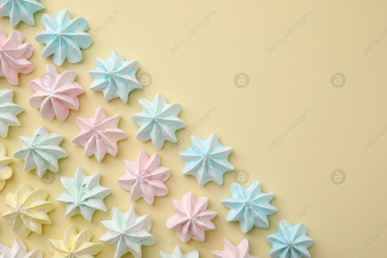 Photo of Delicious meringue cookies on beige background, flat lay. Space for text