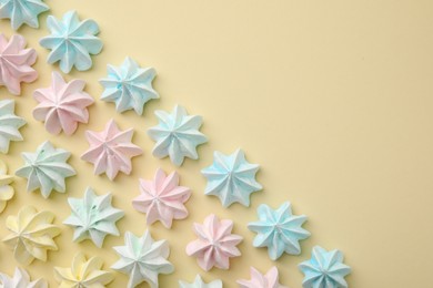 Photo of Delicious meringue cookies on beige background, flat lay. Space for text