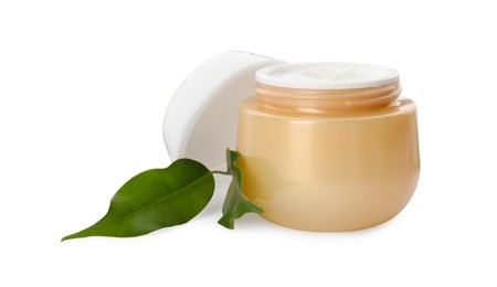 Photo of Face cream in jar and leaves on white background