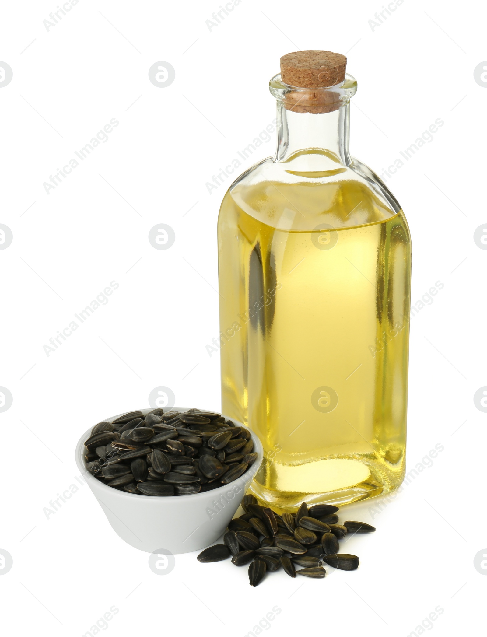 Photo of Vegetable fats. Sunflower oil in glass bottle and seeds isolated on white