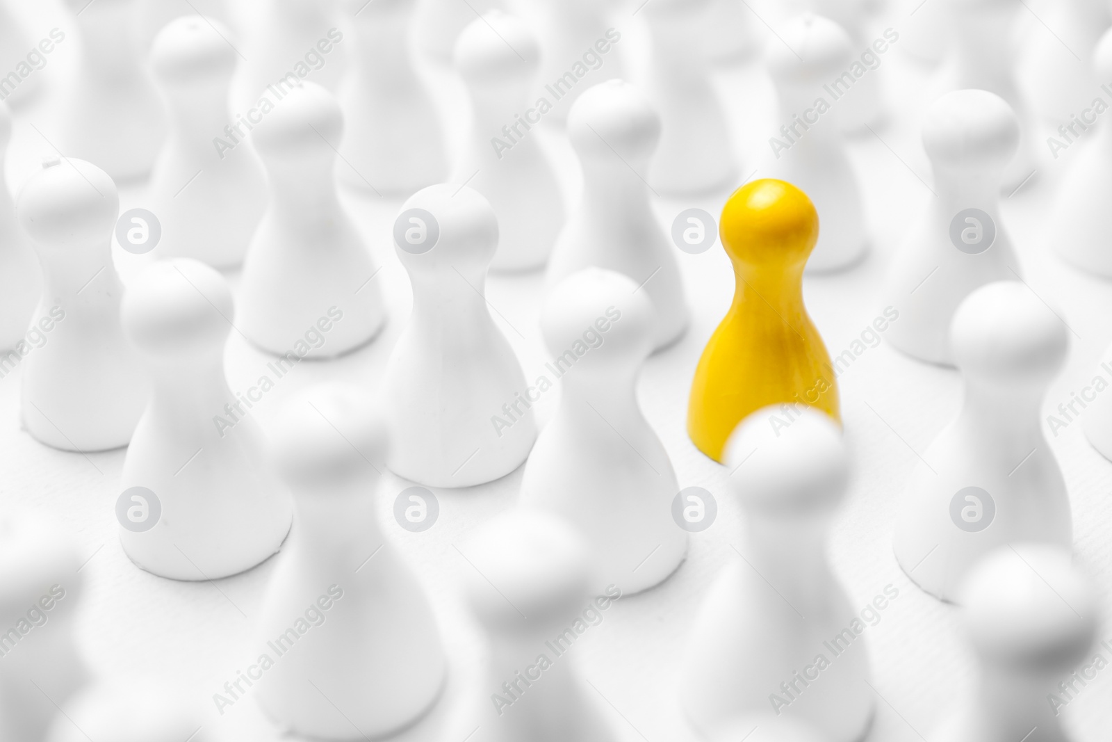 Photo of Yellow pawn among others on white background, closeup. Recruiter searching employee