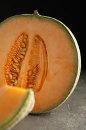 Photo of Tasty fresh cut melon on grey table, closeup