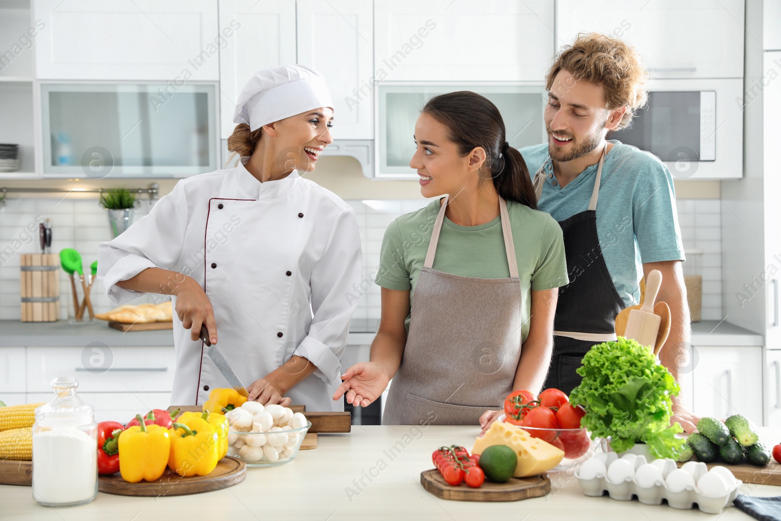 Photo of Group of people and female chef at cooking classes