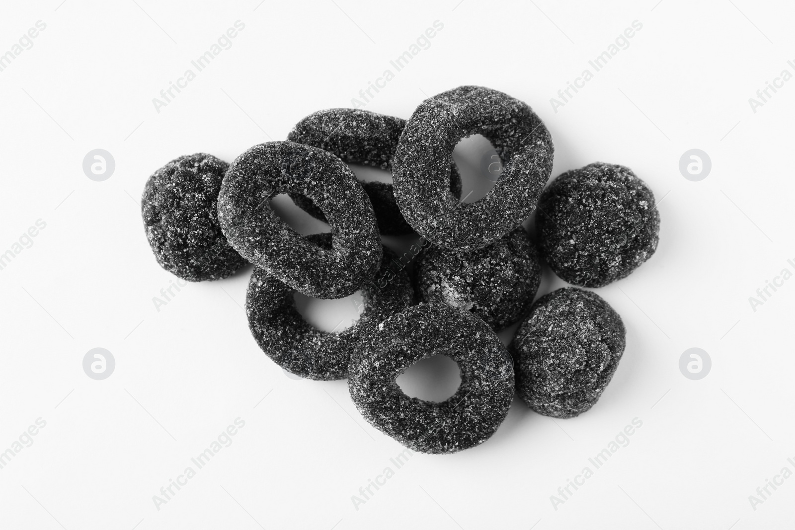 Photo of Tasty liquorice candies on light background, top view