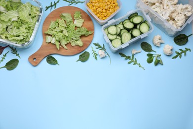 Different containers and wooden board with fresh products on light blue background, flat lay. Space for text