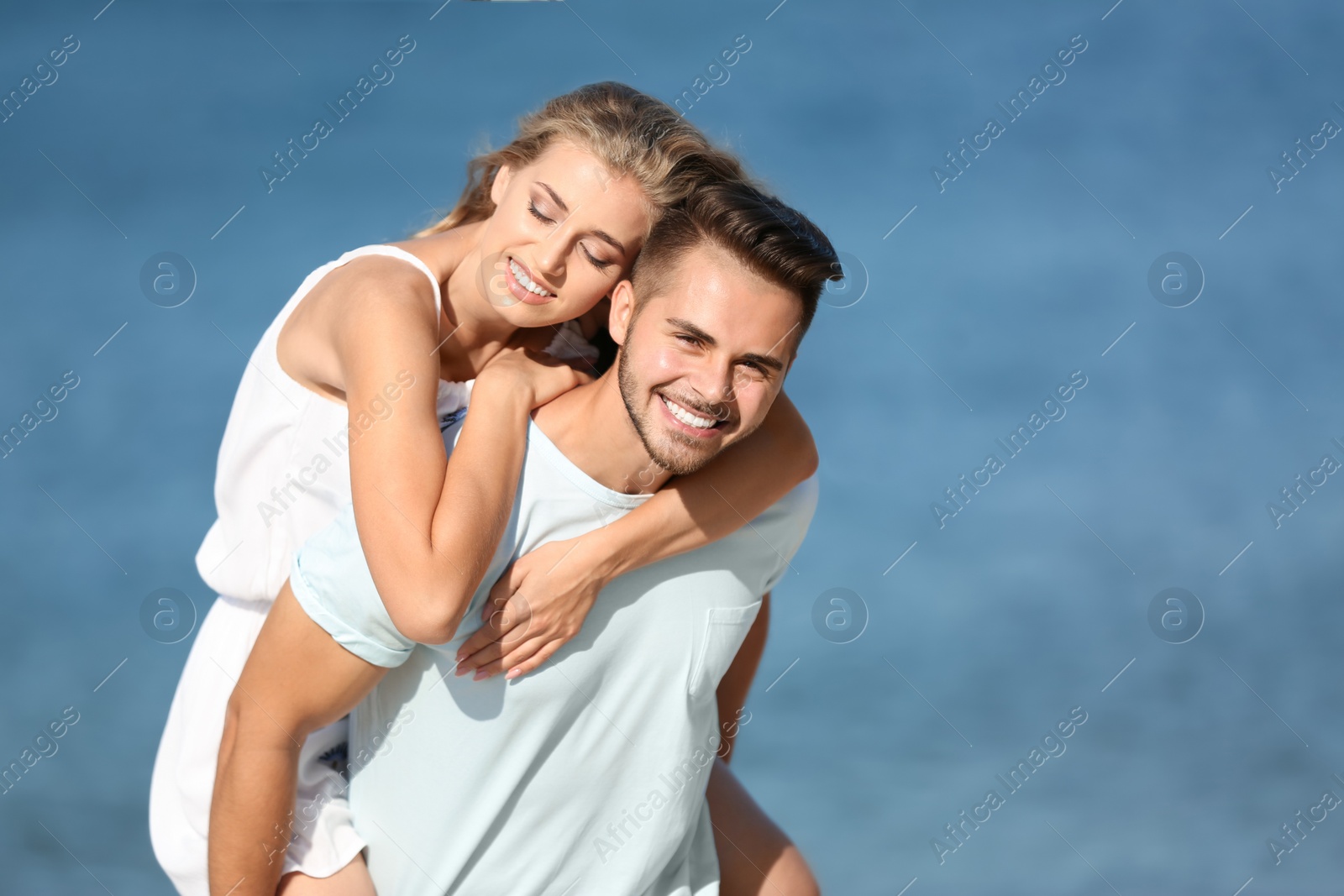 Photo of Happy young couple at beach on sunny day