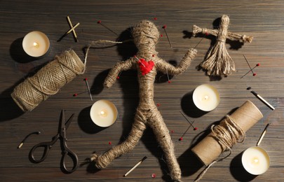 Flat lay composition with voodoo doll on wooden table