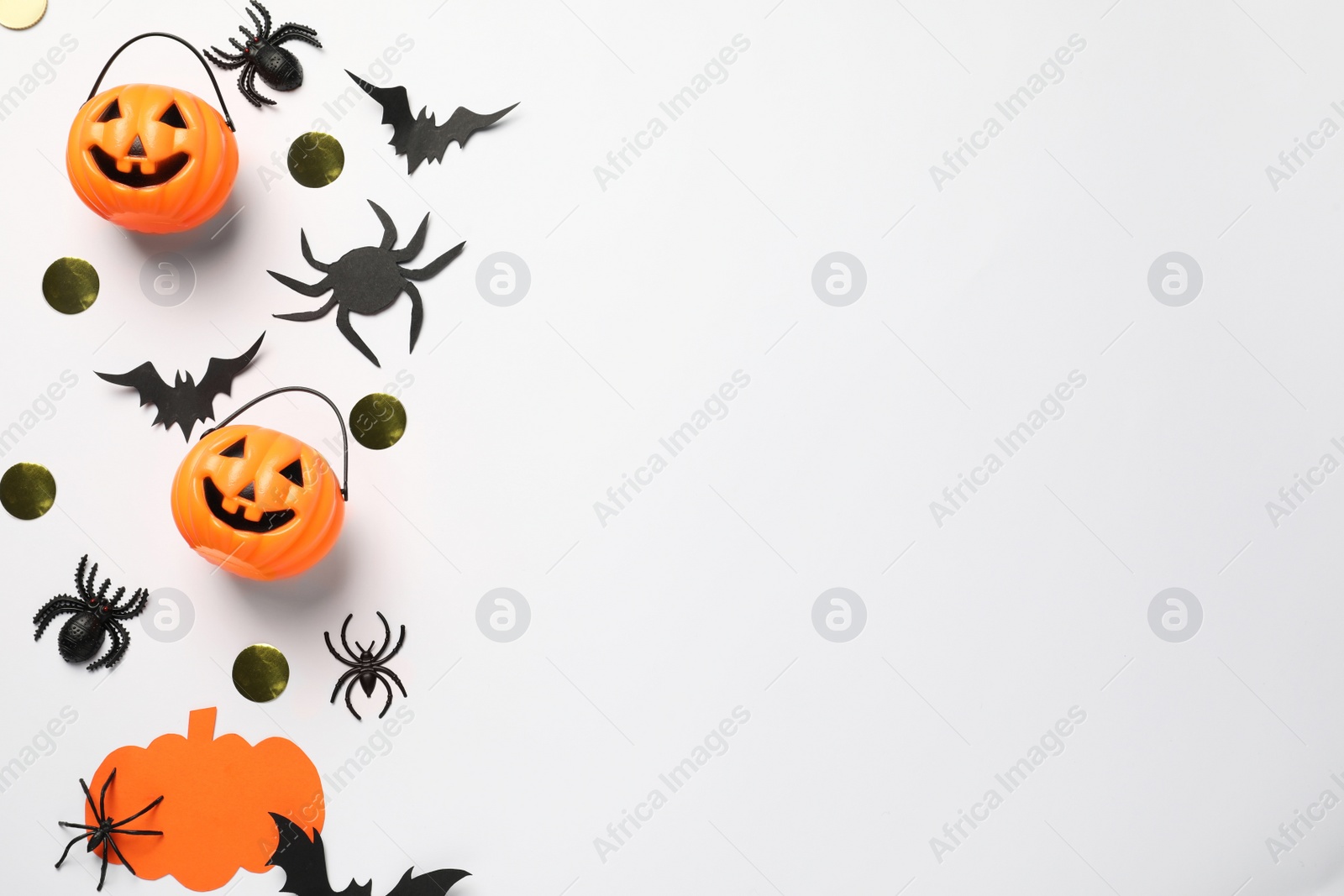 Photo of Flat lay composition with plastic pumpkin baskets, paper bats and spiders on white background, space for text. Halloween celebration