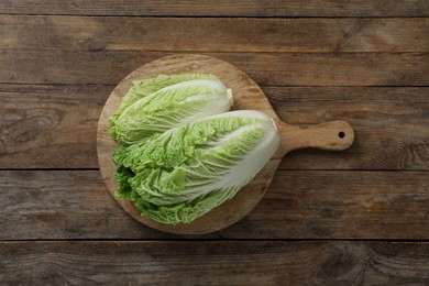 Photo of Fresh ripe Chinese cabbages on wooden table, top view