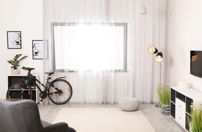 Light living room interior with modern bicycle