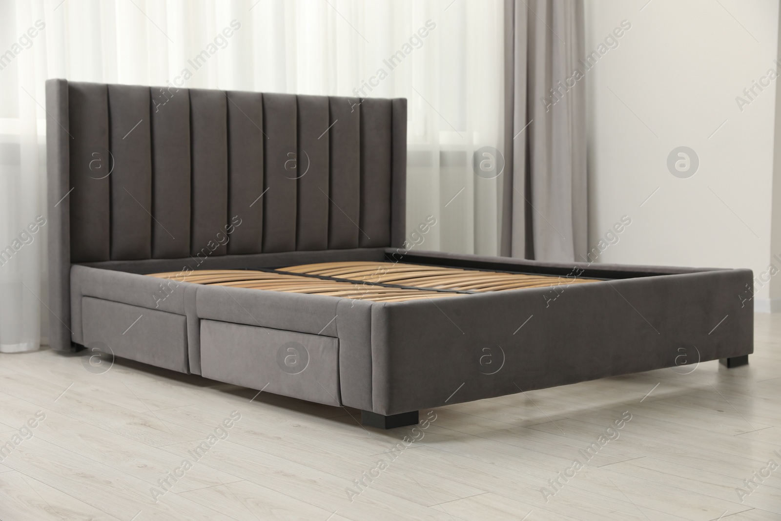 Photo of Modern bed with storage space for bedding under slatted base in room