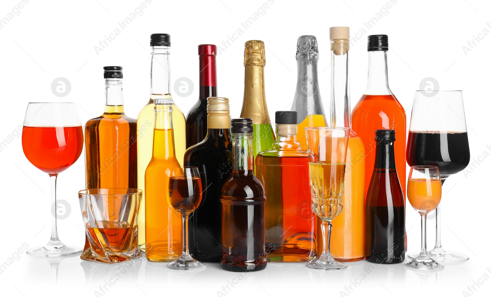 Photo of Bottles and glasses with different alcoholic drinks isolated on white