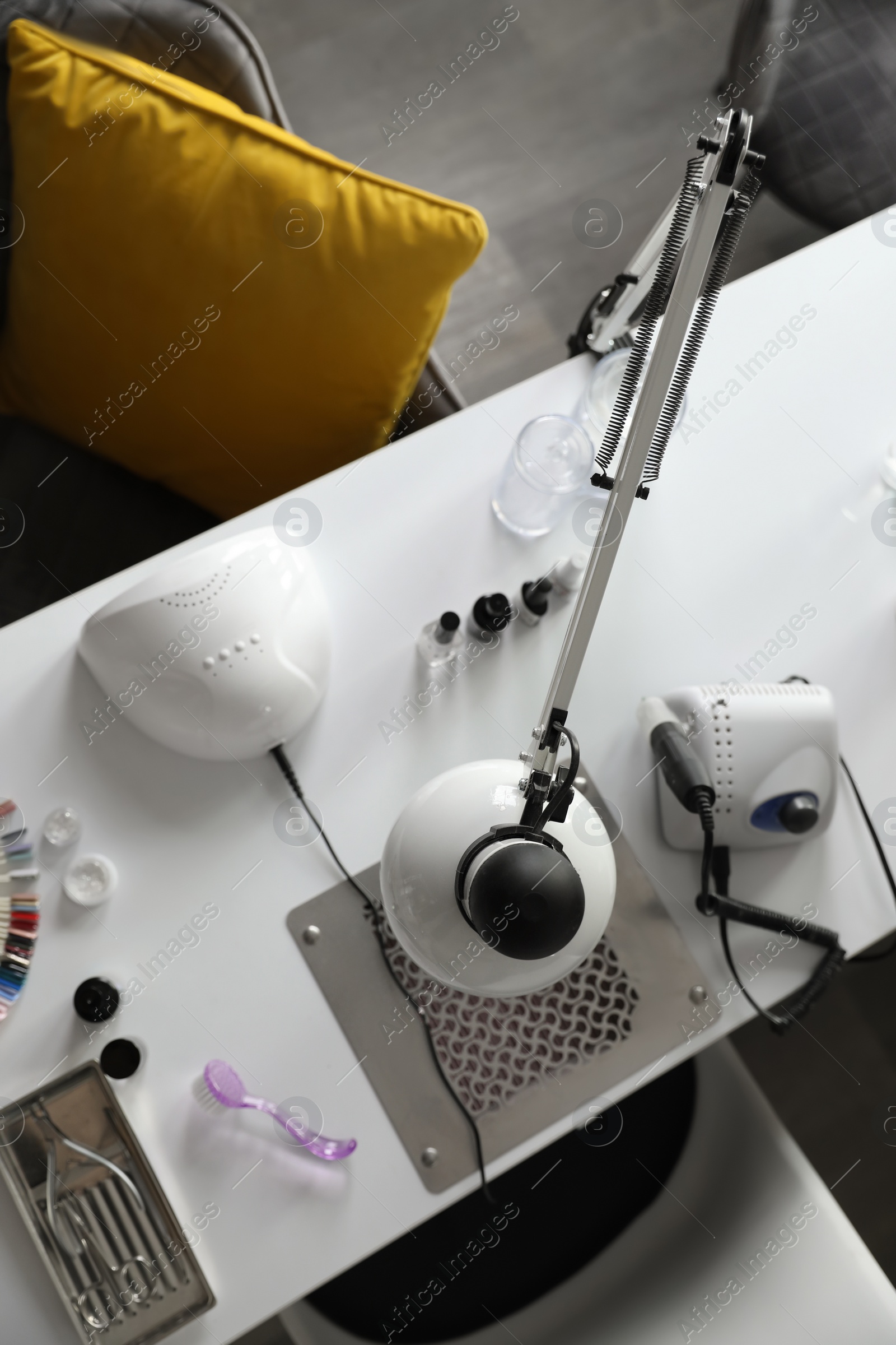 Photo of Professional equipment for manicure on table in beauty salon, top view