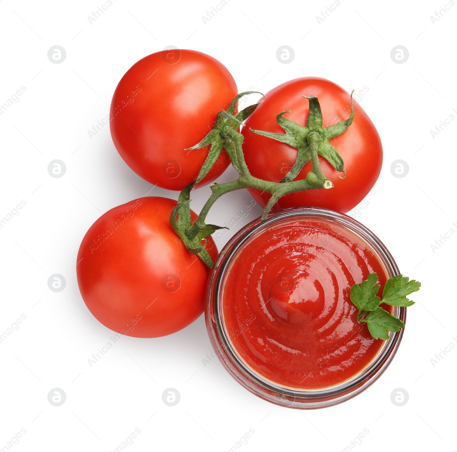 Photo of Tasty ketchup in glass jar and fresh tomatoes isolated on white, top view